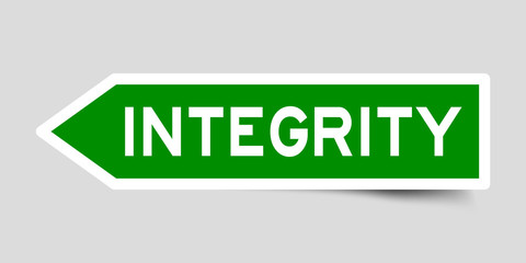 Green color arrow sticker with word integrity on gray background