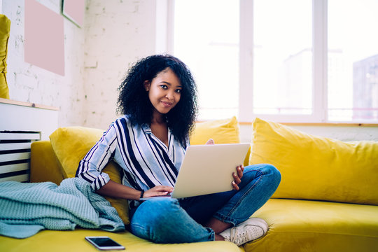 Happy Black Lady Using Laptop On Sofa