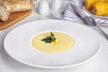 Delicious corn cream soup served on white table