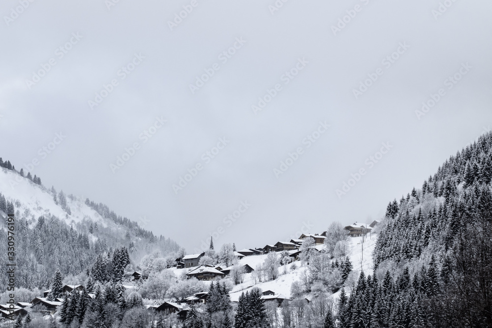 Wall mural village les gets seen from the pied de la plagne under the snow - morzine - france