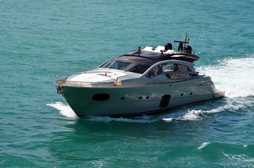 sleek silver motor yacht on the Florida Intra-Coastal Waterway off the southern end of Miami Beach.