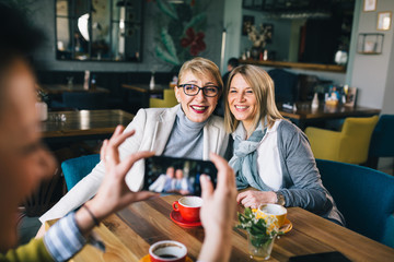 women friends having fun in cafe