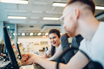 Enthusiastic creative multiracial students using computer for education in library