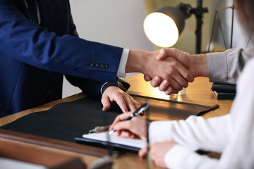 Male lawyer working with clients in office, closeup