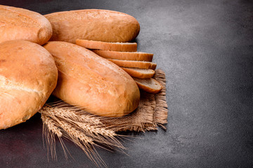 Fresh baked white bread on a brown concrete background