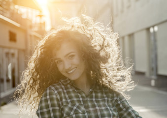 Atmospheric portrait of smiling young natural beautiful lady on