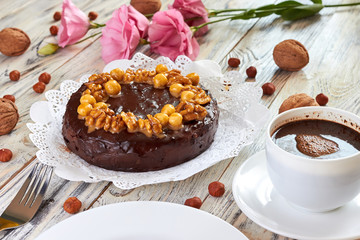 Chocolate cake with cherries, walnuts, almonds and hazelnuts on plate