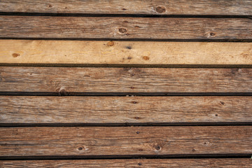 Fototapeta premium Old weathered wooden planks background. Abstract horizontal textured brown panels. 
