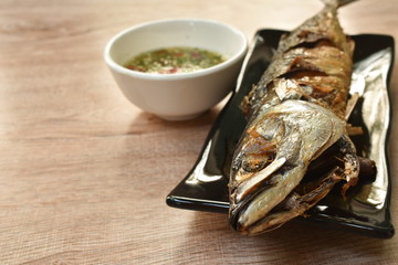 deep  fried saba fish or mackerel on plate dipping spicy sauce