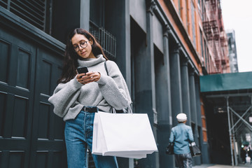 Trendy female with phone on street