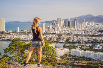 Woman tourist on the background of Nha Trang city. Travel to Vietnam Concept