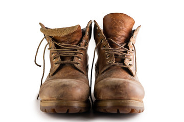 Old leather brown boots isolated in a white background.