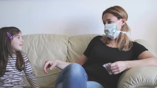 mother with viral infection of coronavirus covid 19 keep her baby at distance as precautionary measure against contagion