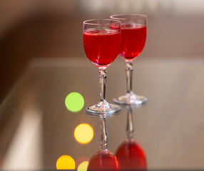 Everything prepared for a party, glasses, masks, lights and fruit with their reflections.
