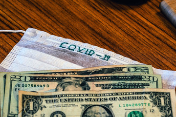 corona virus US economic crisis dollars and virus mask