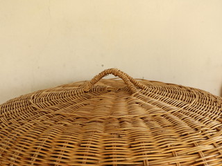 A cone-shaped cover made of Rattan for keeping food away from flies.