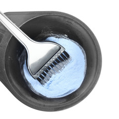 Bowl with hair dye and brush isolated on white, top view