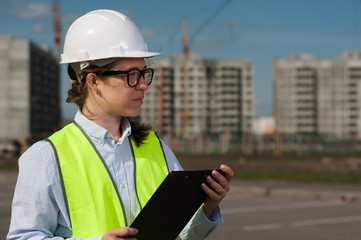 Chief Engineer Woman In Green Vest And Helmet