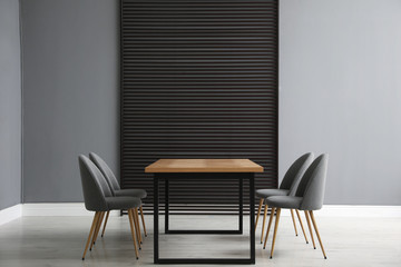Table and chairs in room. Stylish interior design
