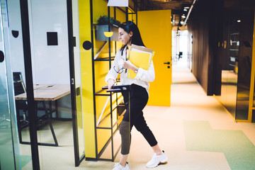 Obraz premium Adult female opening office door in workspace