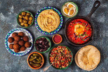Falafel, hummus, shakshuka, Israeli salad - traditional dishes of Israeli cuisine.