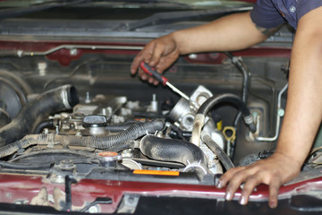 Plakat Image of a mechanic checking and fixing the engine