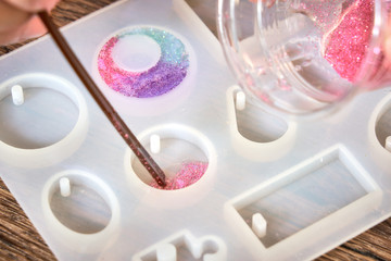 Pouring glitter pink resin to mold , process of prepare for make an accessories