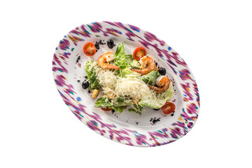 Healthy Grilled shrimp Caesar Salad with parmesan Cheese, black olives and Croutons isolated on white background