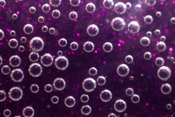 Transparent bubbles on a purple background. Lots of bubbles on a flat surface