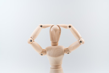 Wooden dummy proudly presents some invisible thing, isolated on white background, copy space for your object or text