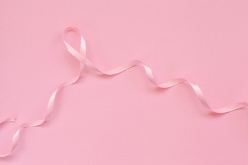 Pink ribbon breast cancer on pink background.