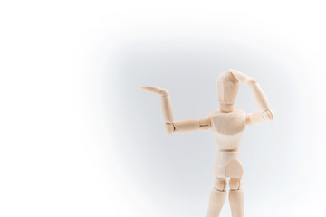 Wooden dummy proudly presents some invisible thing, isolated on white background, copy space for your object or text