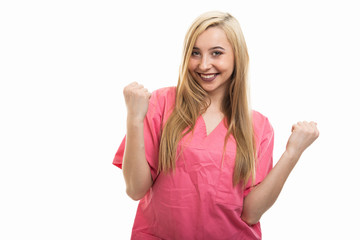 Fototapeta premium Portrait of female nurse wearing scrubs making happy gesture