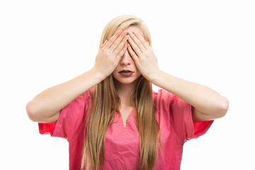 Portrait of young female nurse covering eyes like blind gesture