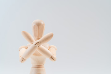 Refusal gesture, Wooden dummy, crossed hands on white background, copy space for your object or text