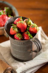 Strawberries in antique metal tin