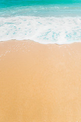 Fototapeta na wymiar Wave and sand beach background with copy space.