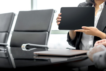 Businesswoman with a tablet discussing business