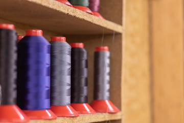 Naklejka premium Colorful thread spools used in fabric and textile industry