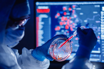 Medical bioengineer working on development vaccines 2019-ncov coronavirus in pharmacy laboratory. Blue colour background