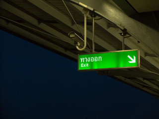 Fototapeta premium Green banner call exit way in Bangkok Sky Train System (BTS)