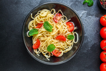 spaghetti pasta with tomatoes, Italian cuisine main dish, vegetarian menu concept background. top view. copy space for text