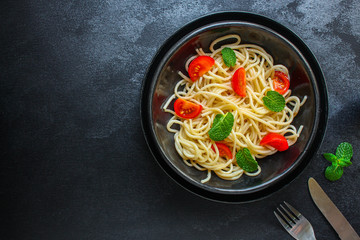 spaghetti pasta with tomatoes, Italian cuisine main dish, vegetarian menu concept background. top view. copy space for text