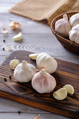 Healthy and wholesome food. Fresh garlic in a wicker basket on a wooden table