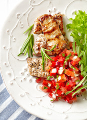 Grilled Pork Tenderloin with Tomato Salsa and Arugula.  Top view.