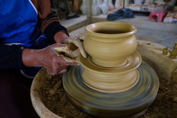 Closeup of Local woman demonstrates on making traditional clay jar called 