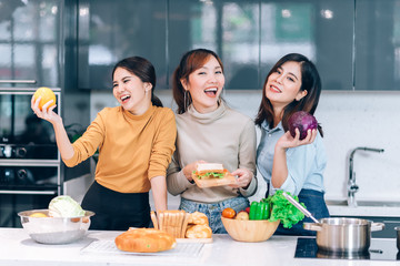 Happpy Asian Friends Cooking Together in the Kitchen at Home - Hobby Lifestyle Concept