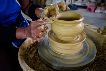 Closeup of Local woman demonstrates on making traditional clay jar called 
