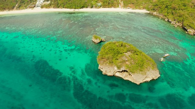 Tropical sandy beach near the blue lagoon and corall reef, aerial view Boracay, Philippines. Ilig Iligan Beach. Summer and travel vacation concept.