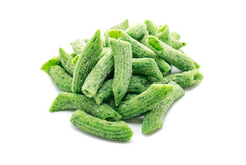 Raw penne egg pasta with spinach isolated on a white background